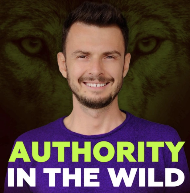 Authority in the Wild Smiling man with short dark hair and trimmed beard wearing a purple shirt. Behind him, the faint image of a wolf’s face with piercing eyes is blended into the background. Bold text across the bottom reads: “AUTHORITY IN THE WILD,” with “AUTHORITY” in bright green and “IN THE WILD” in white.